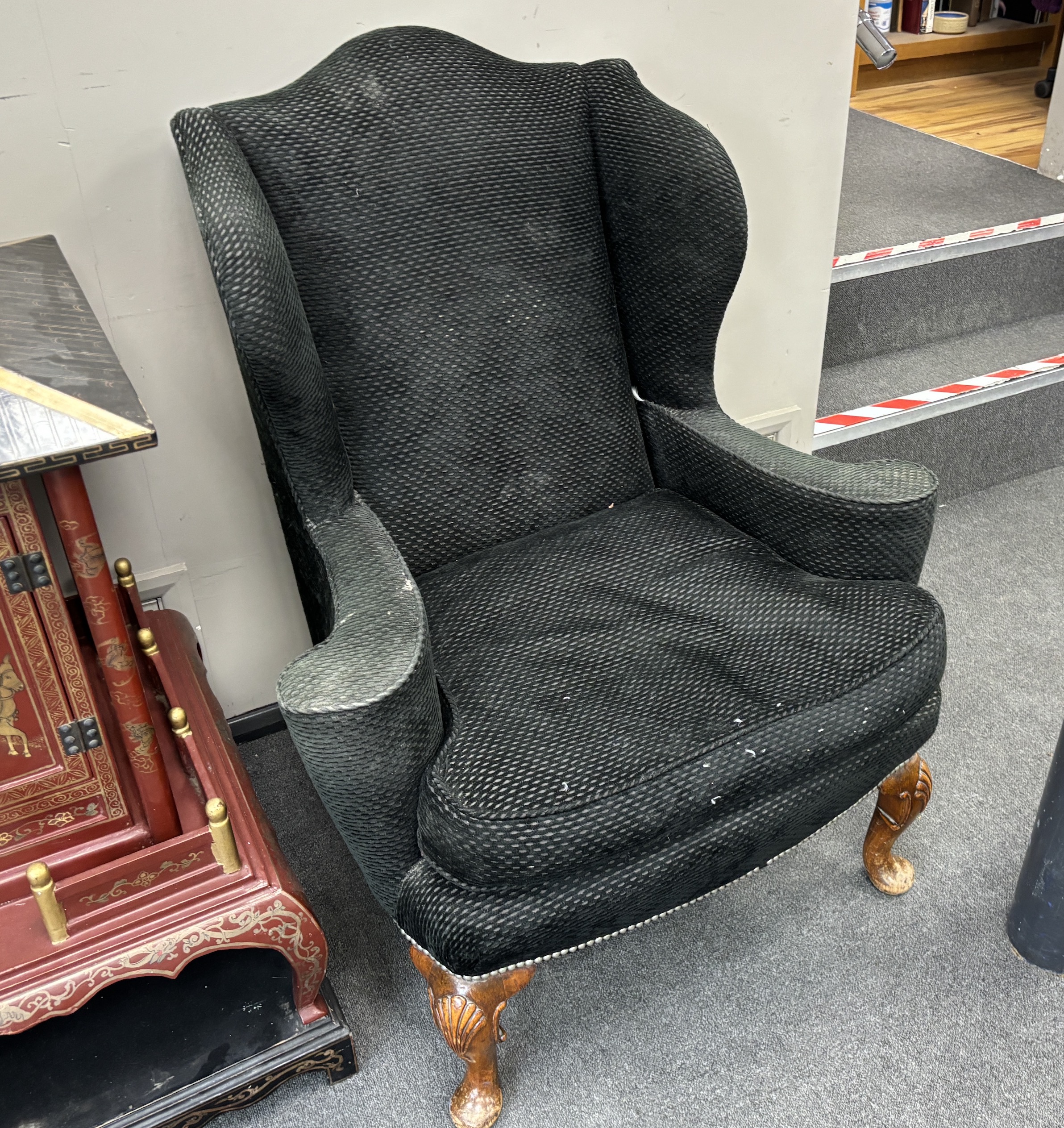 A pair of Queen Anne revival upholstered wing back armchairs on shell carved cabriole legs, width 88cm, depth 78cm, height 108cm.